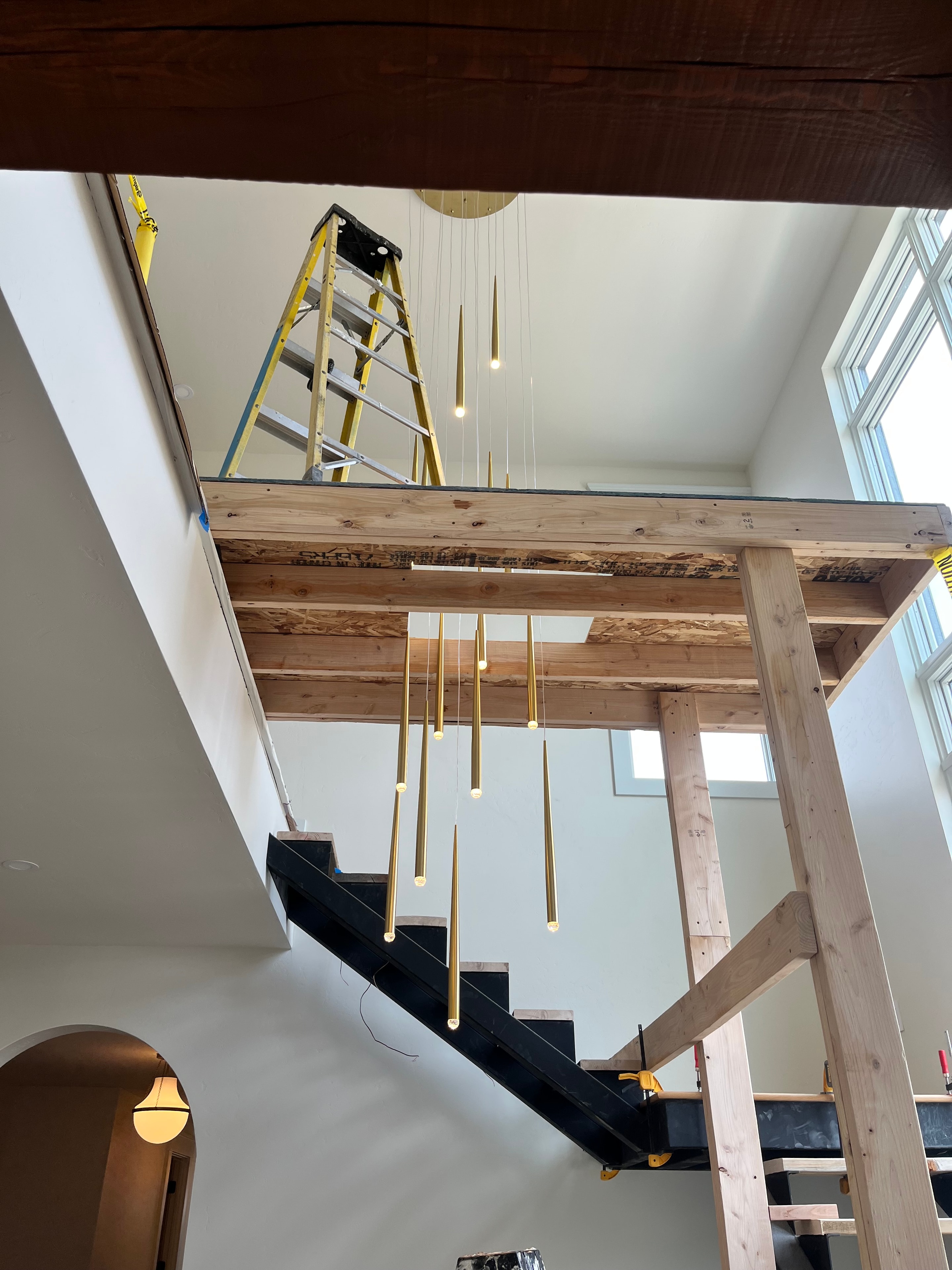 Electrician working on electrical rough-in at a new home construction site